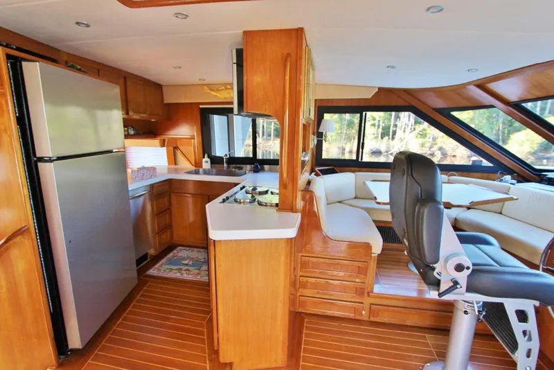 Slide: The Image of Luxurious 1992 Tollycraft 53 Motor Yacht interior with modern kitchen and spacious seating area. - 5