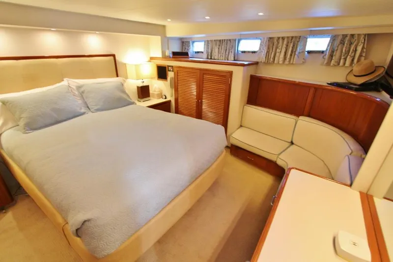 Slide: The Image of Luxurious bedroom interior of 1992 Tollycraft 53 Motor Yacht with cozy bed and seating area. - 9