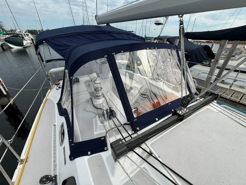 Slide: The Image of 2007 Catalina 309 sailboat with blue canopy docked at marina. - 10