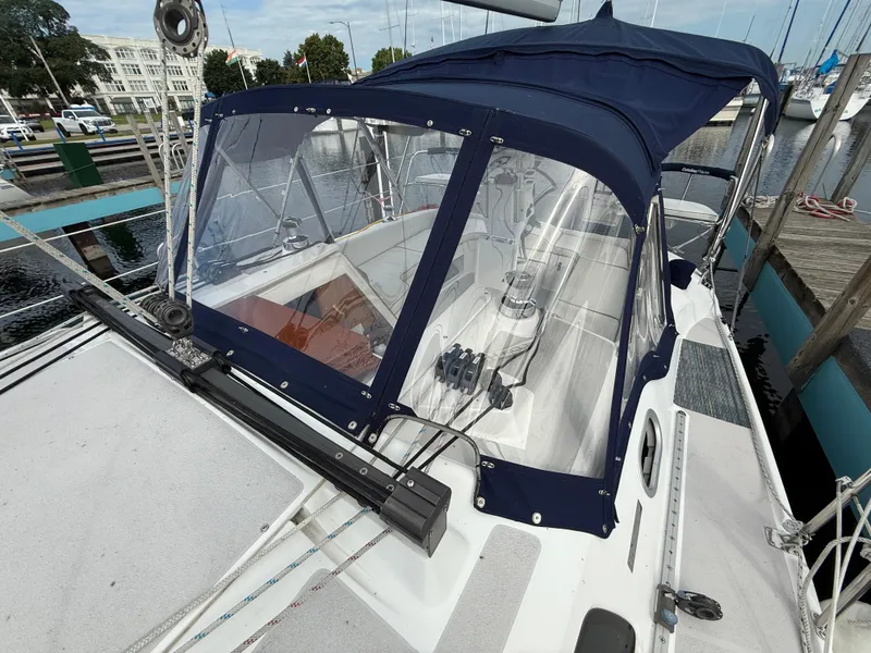 Slide: The Image of Catalina 309 sailboat, 2007 model, docked with blue canopy and clear enclosure. - 12