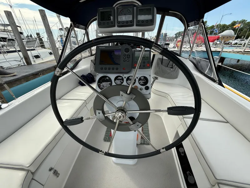 Slide: The Image of Steering wheel and cockpit of a 2007 Catalina 309 sailboat at a marina. - 17