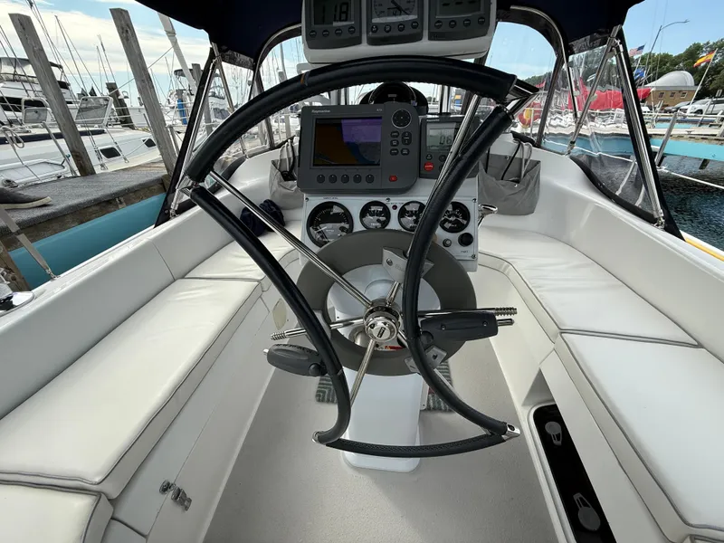 Slide: The Image of Cockpit of a 2007 Catalina 309 sailboat with steering wheel and navigation instruments. - 18