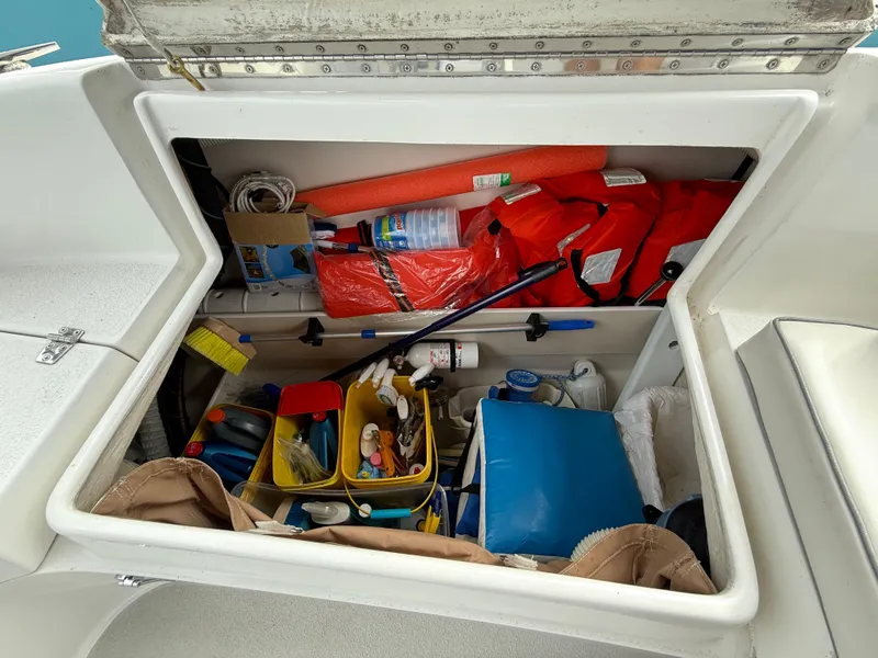 Slide: The Image of Storage compartment of a 2007 Catalina 309 sailboat filled with boating essentials and safety gear. - 41