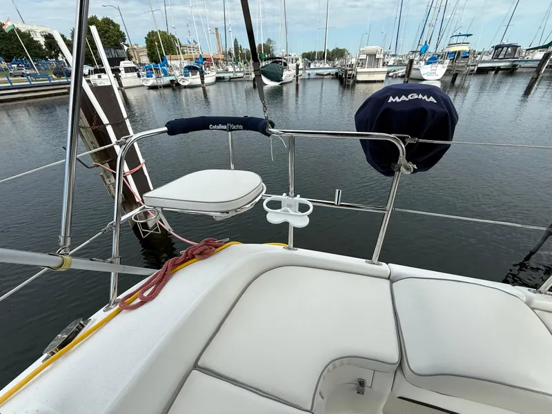 Slide: The Image of Catalina 309 sailboat deck view at marina, featuring seating and railing, 2007 model. - 6
