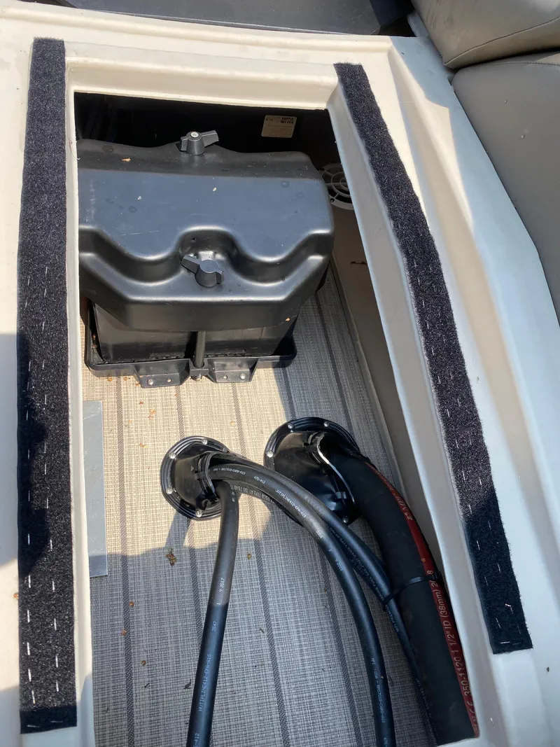 Slide: The Image of 2018 Bennington 25 GCW boat storage compartment with cables and battery box. - 25