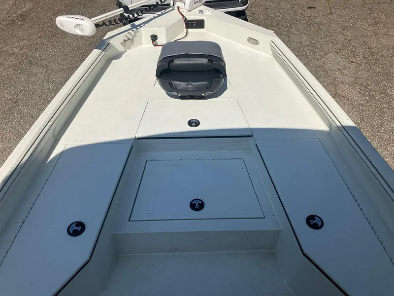 Slide: The Image of 2022 Excel 220 Bay Pro boat deck with storage compartments and trolling motor. - 10
