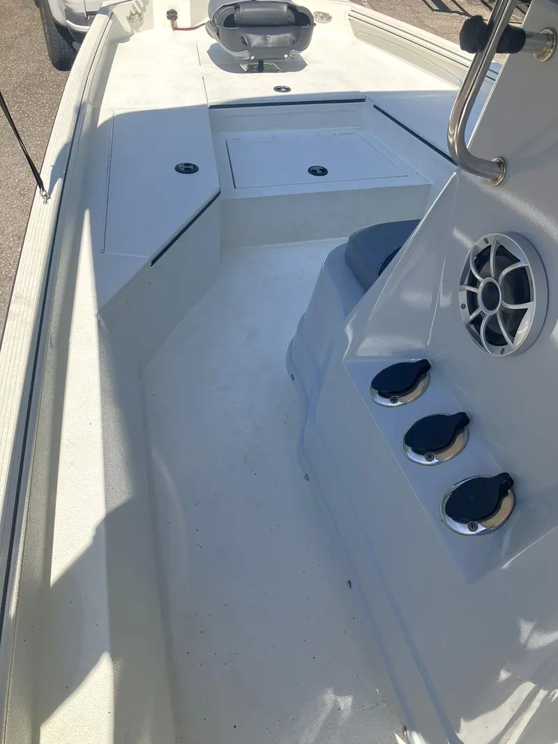 Slide: The Image of 2022 Excel 220 Bay Pro boat interior with seating and storage compartments. - 13