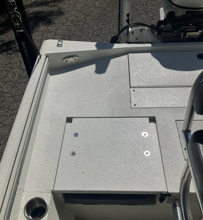 Slide: The Image of 2022 Excel 220 Bay Pro boat deck with storage compartments and cup holder. - 15