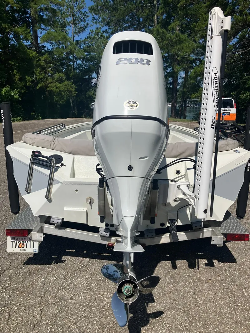 Slide: The Image of 2022 Excel 220 Bay Pro boat with powerful outboard motor, parked on a trailer. - 19