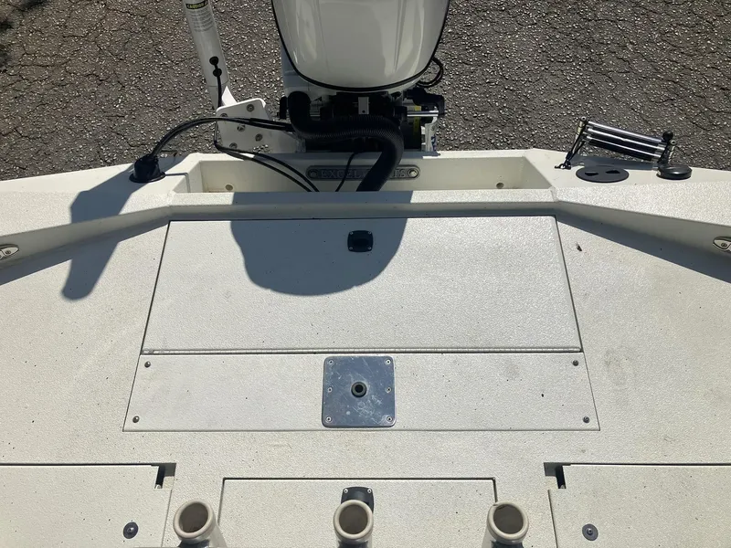 Slide: The Image of 2022 Excel 220 Bay Pro boat deck with motor and rod holders. - 20