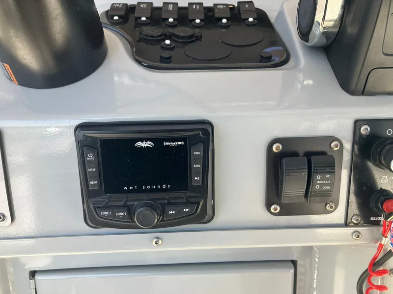 Slide: The Image of 2022 Excel 220 Bay Pro boat dashboard with Wet Sounds audio system and controls. - 9