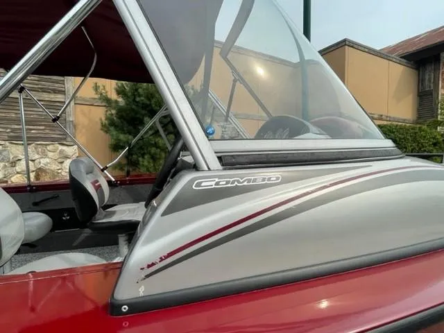 Slide: The Image of 2014 Tracker Targa V-18 Combo boat with red and gray detailing. - 12