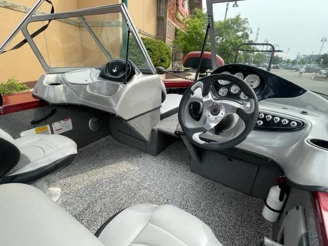 Slide: The Image of 2014 Tracker Targa V-18 Combo boat interior with steering wheel and dashboard controls. - 13