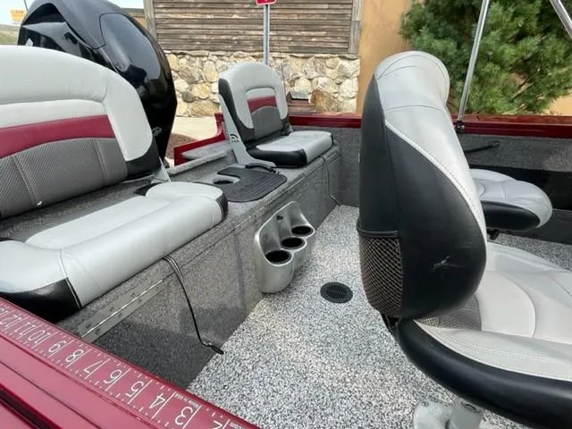 Slide: The Image of 2014 Tracker Targa V-18 Combo boat interior with seating and cup holders. - 14