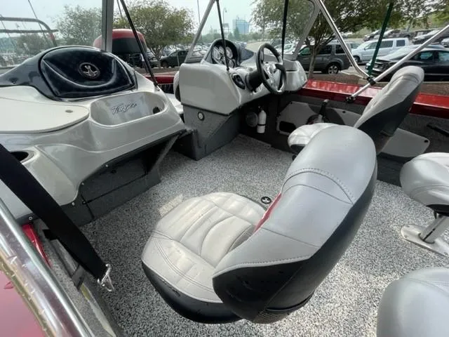 Slide: The Image of 2014 Tracker Targa V-18 Combo boat interior with gray seating and steering console. - 5