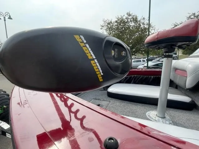 Slide: The Image of 2014 Tracker Targa V-18 Combo boat with Minn Kota trolling motor, red deck, and seating. - 9