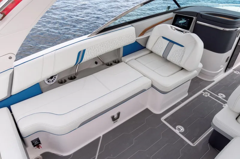 Slide: The Image of 2026 Regal LS9 Surf boat interior with white seating and blue accents on water. - 18
