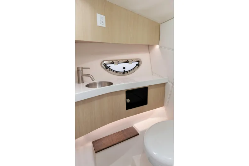 Slide: The Image of 2026 Regal LS9 Surf boat interior bathroom with sink, porthole, and modern design. - 20