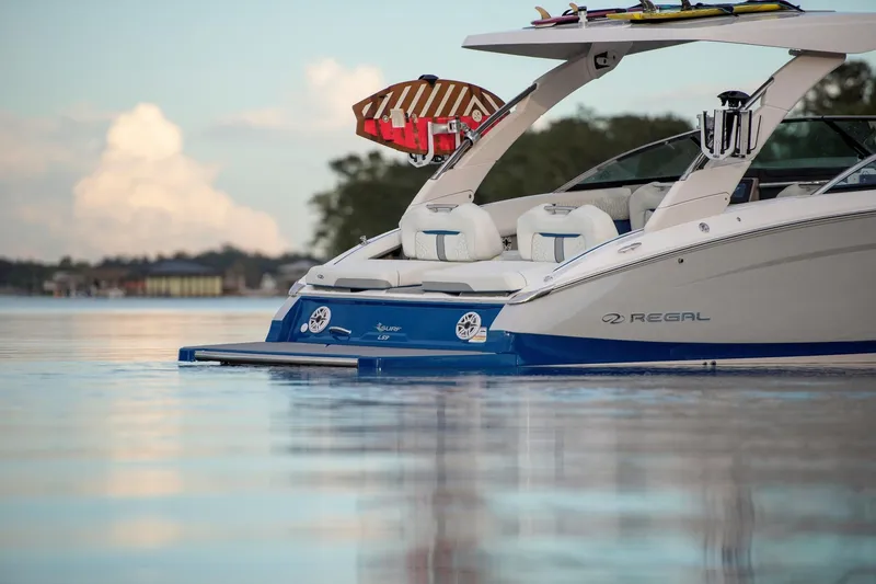Slide: The Image of 2026 Regal LS9 Surf boat on calm water, featuring sleek design and luxury seating. - 9