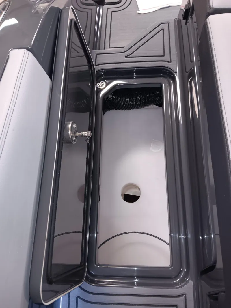 Slide: The Image of Open storage compartment in 2026 Cobalt R4 Surf boat interior. - 14