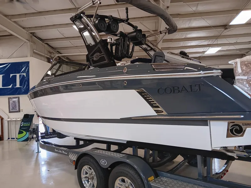 Slide: The Image of 2026 Cobalt R4 Surf boat displayed indoors on a trailer. - 3