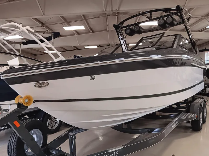 Slide: The Image of 2026 Cobalt R4 Surf boat displayed indoors on a trailer. - 4