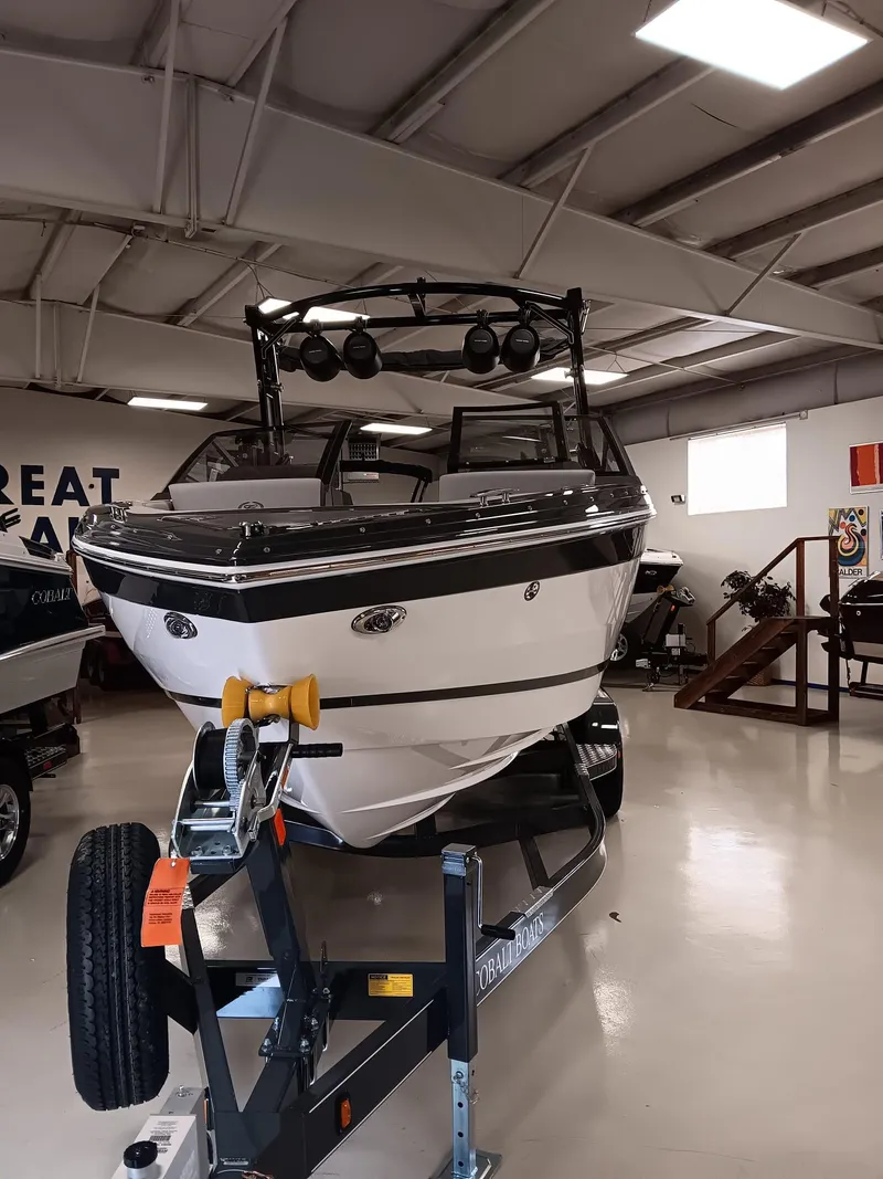 Slide: The Image of 2026 Cobalt R4 Surf boat on trailer in showroom. - 5