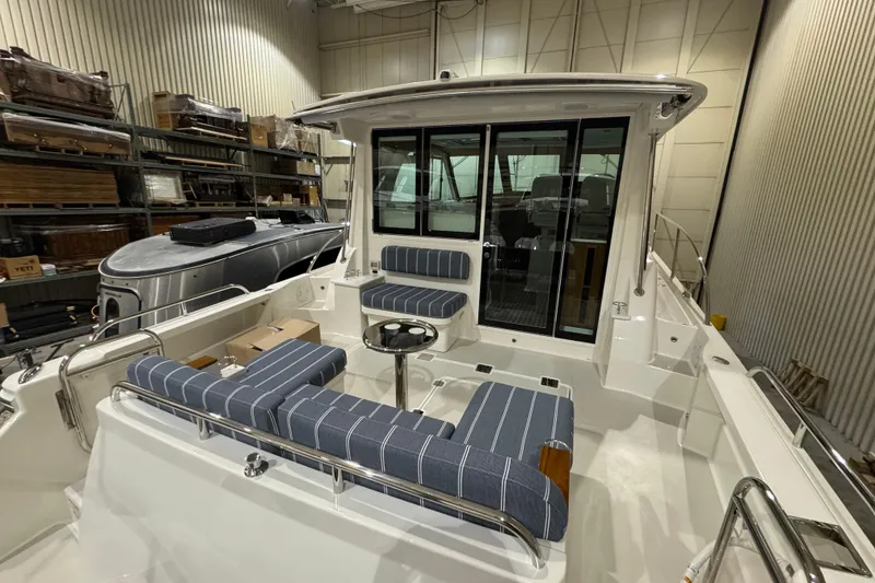 Slide: The Image of 2026 Back Cove 39O boat in indoor storage, side view, sleek design. - 2