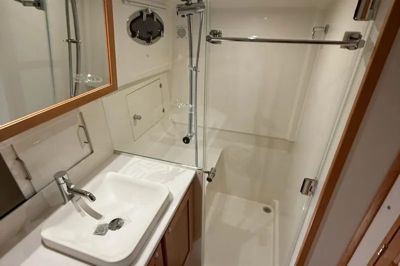 Slide: The Image of 2026 Back Cove 39O yacht bathroom with sink, shower, and modern fixtures. - 43