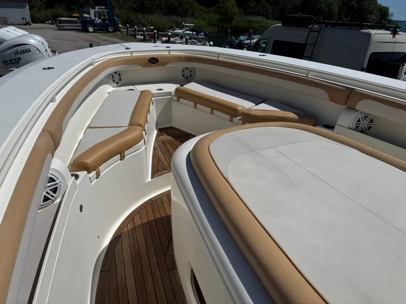 Slide: The Image of 2011 Scout 345 XSF boat interior with tan seating and wood flooring. - 11