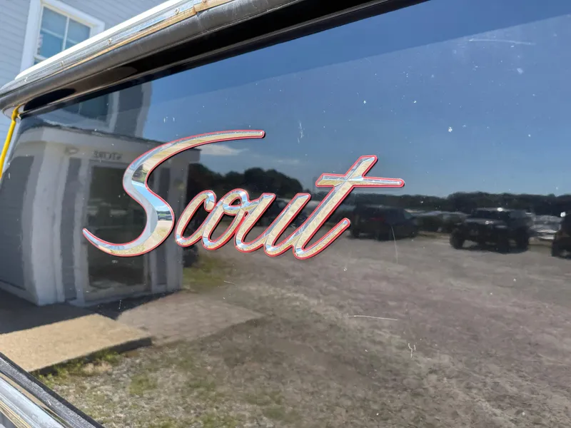 Slide: The Image of Scout 345 XSF 2011 logo on vehicle window, reflecting outdoor scenery. - 12
