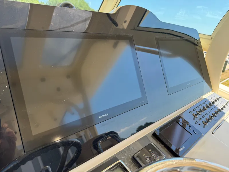 Slide: The Image of Control panel of 2011 Scout 345 XSF boat with Garmin displays and Yamaha controls. - 17
