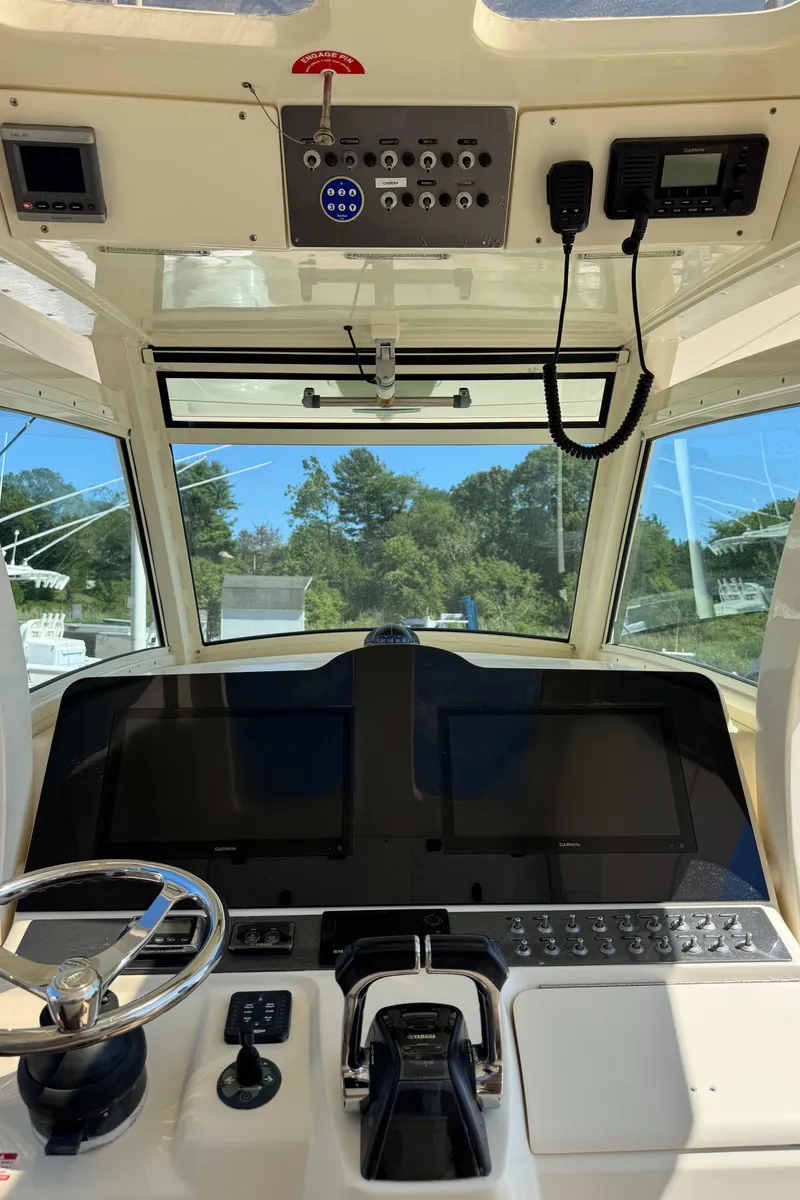 Slide: The Image of Helm of 2011 Scout 345 XSF boat with modern controls and navigation equipment. - 19