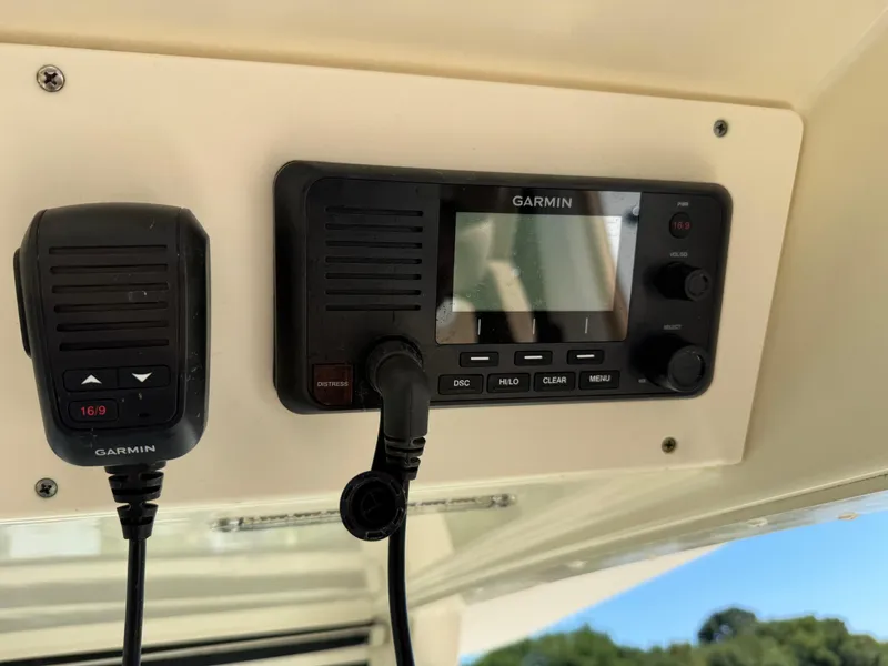 Slide: The Image of Garmin marine radio and microphone on 2011 Scout 345 XSF boat dashboard. - 20