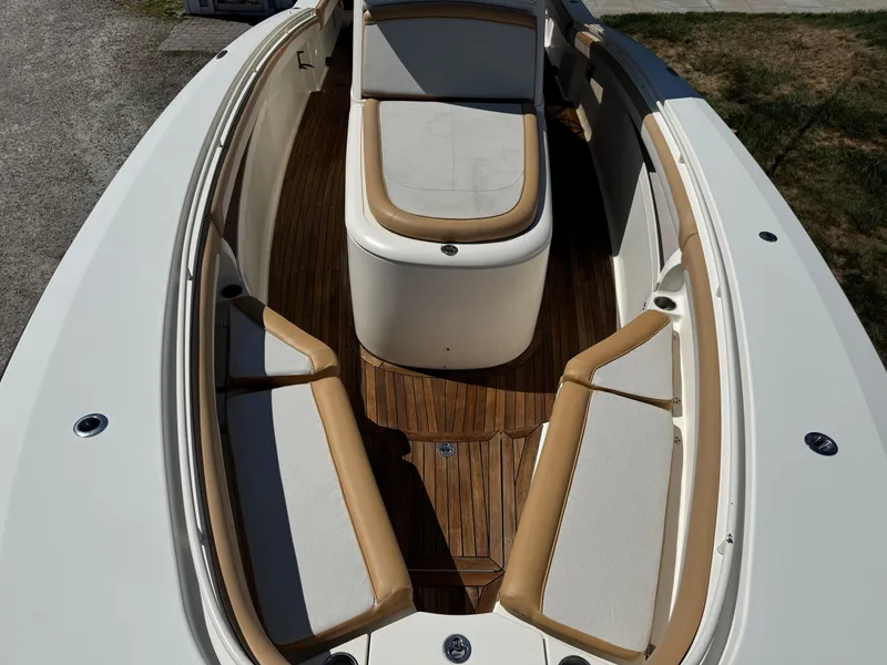 Slide: The Image of 2011 Scout 345 XSF boat interior with cushioned seating and wooden flooring. - 28