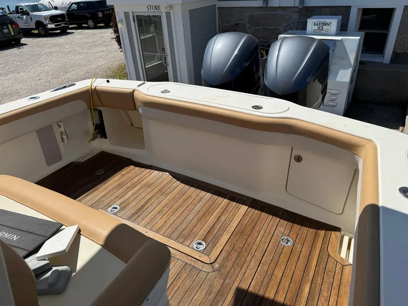 Slide: The Image of 2011 Scout 345 XSF boat interior with wooden deck and twin outboard motors. - 34