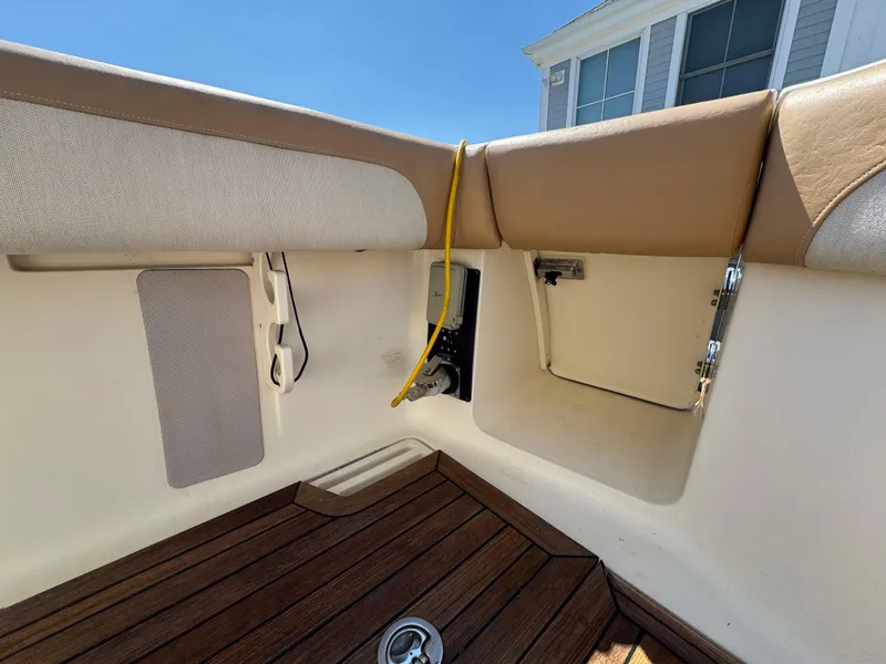 Slide: The Image of Interior view of a 2011 Scout 345 XSF boat with wooden flooring and storage compartment. - 40