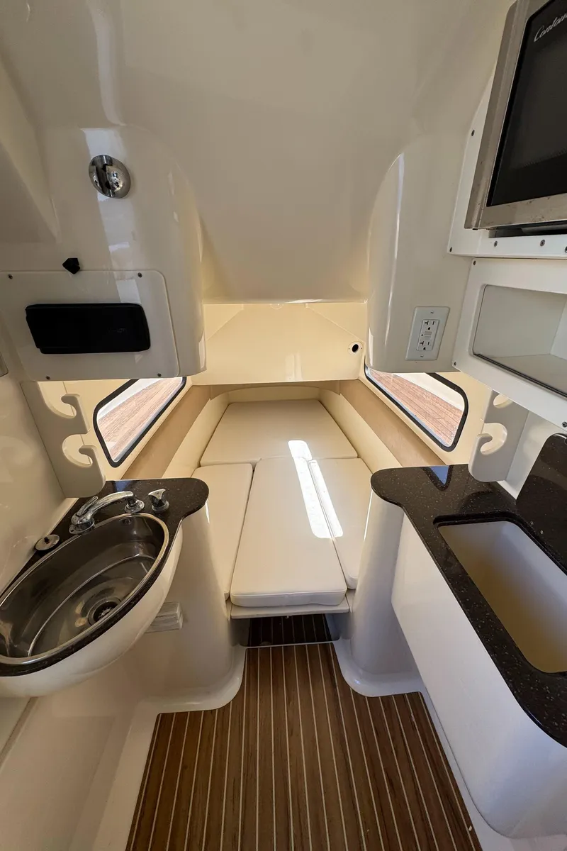 Slide: The Image of 2011 Scout 345 XSF cabin interior with sink, seating, and wood flooring. - 51