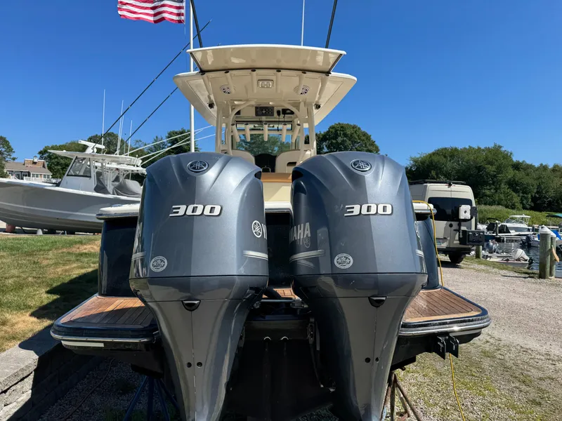 Slide: The Image of 2011 Scout 345 XSF boat with twin Yamaha 300 engines, docked under clear blue sky. - 6