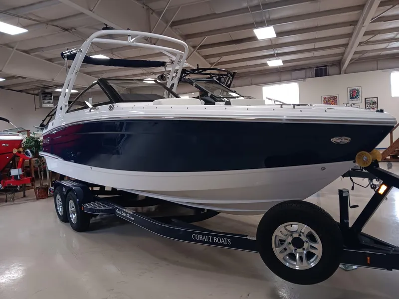 Slide: The Image of 2026 Cobalt R4 boat on trailer in indoor showroom setting. - 3