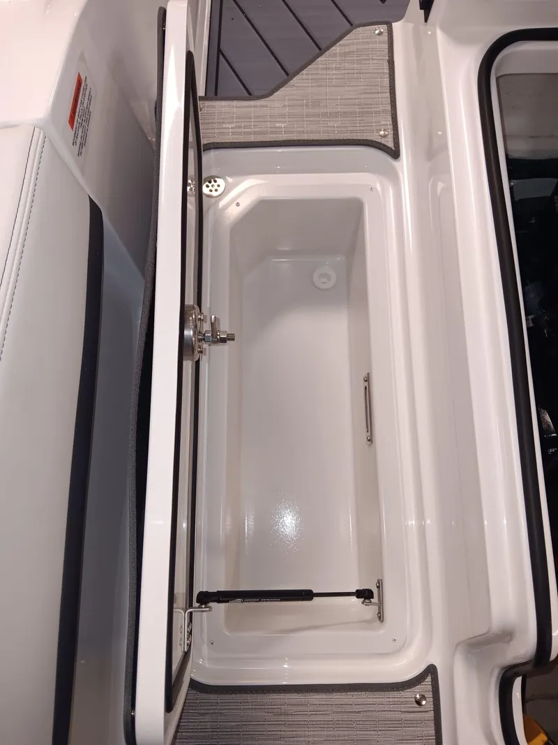 Slide: The Image of Open storage compartment in 2026 Cobalt R4 boat interior. - 7