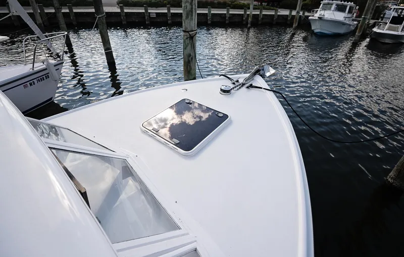 Slide: The Image of Control panel and interior of a 1969 Bertram 31 Classic boat, featuring wood accents and modern appliances. - 12