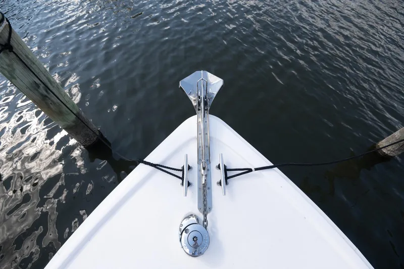 Slide: The Image of 1969 Bertram 31 Classic boat docked at marina, reflecting sky on hatch. - 13