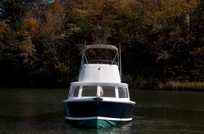Slide: The Image of 1969 Bertram 31 Classic boat dashboard with navigation screens and controls. - 19
