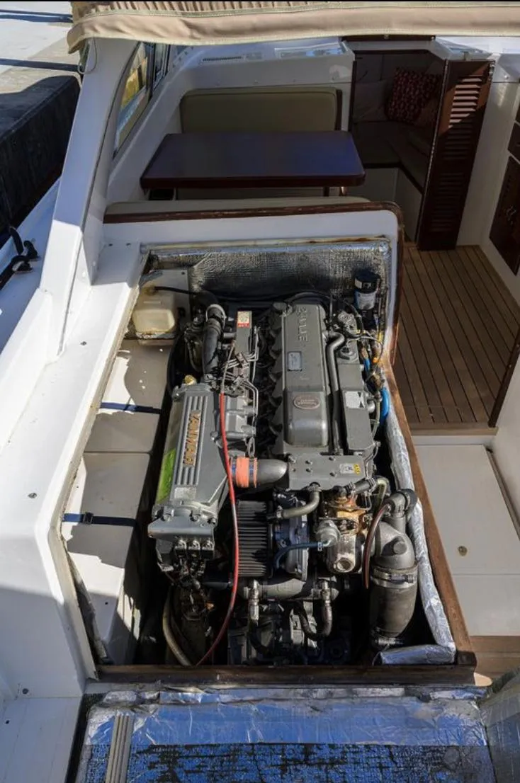 Slide: The Image of Engine compartment of a 1969 Bertram 31 Classic boat, showcasing detailed mechanical components. - 20