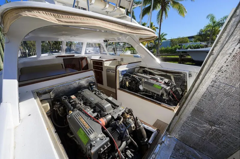 Slide: The Image of 1969 Bertram 31 Classic yacht with open engine compartments, showcasing dual engines and spacious interior. - 21