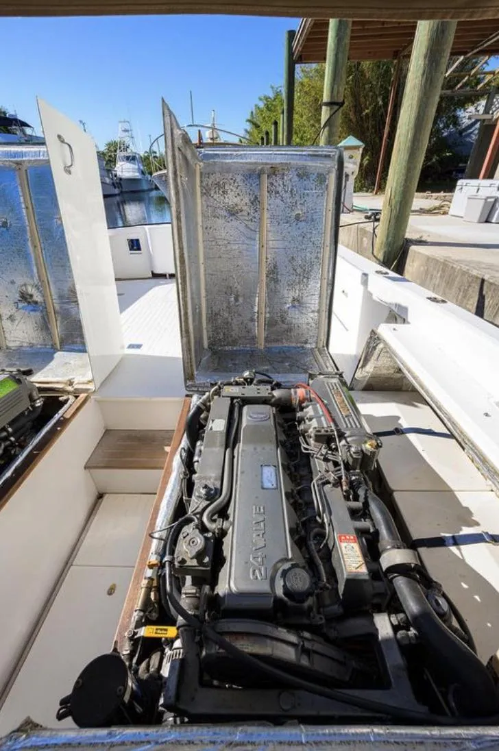 Slide: The Image of Engine compartment of a 1969 Bertram 31 Classic boat, showcasing detailed mechanical components. - 22