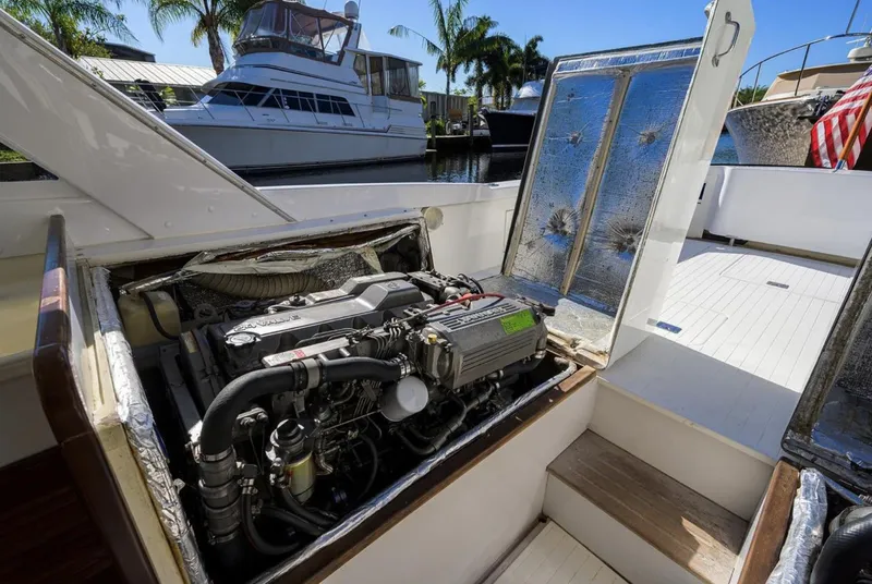 Slide: The Image of Engine compartment of a 1969 Bertram 31 Classic boat, docked near other vessels. - 24