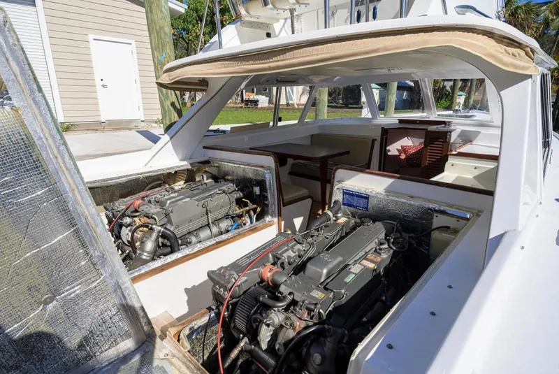 Slide: The Image of 1969 Bertram 31 Classic boat with open engine compartments, showcasing dual engines and cabin interior. - 27