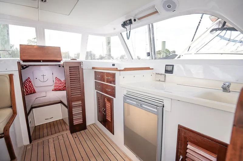 Slide: The Image of Interior of 1969 Bertram 31 Classic boat with wooden table and cushioned seating. - 7